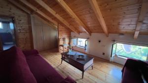 a living room with a couch and a table at The Mountain Attic in Përmet