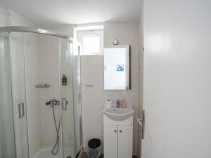 a bathroom with a shower and a sink at Votsalo in Kardamaina +5 photos