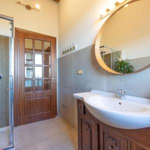 a bathroom with a sink and a mirror and a shower at Terrazza panoramica, 3 camere e 3 bagni in Collecorvino +11 photos