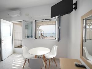 a room with a table and chairs and a window at Votsalo in Kardamaina