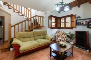 a living room with a couch and a stair case at Casa cerca Playa Cuevas del Mar Llanes - River in Llanes