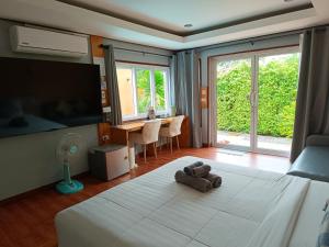 a bedroom with a bed with a teddy bear on it at Anita dream house in Khao Sok National Park