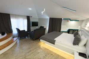 a bedroom with a bed and a living room at Midis Otel in Edirne