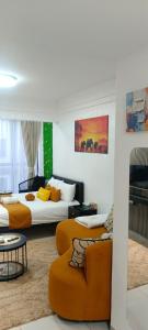 a living room with two beds and a couch at Elite Homes furnished Studio near JKIA in Syokimau