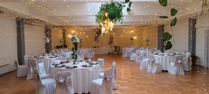 a banquet hall with white tables and chairs and lights at Hotel Nicolás Temuco in Temuco