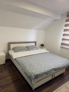 a bedroom with a bed in a white room at Vila Pavle in Užice