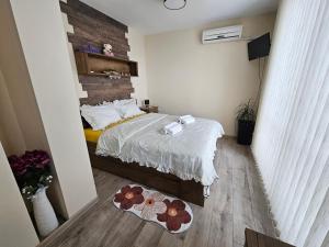 a small bedroom with a bed and a wooden floor at Desitas home in Plovdiv