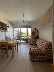 a living room with a couch and a table at Hirmentaz in Bellevaux