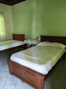 a bedroom with a large bed and two tables at Nice place in Marawila