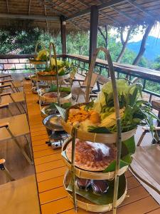 a row of plates of food on a table at ไร่ชาอาโซ -ที่พักดอยช้าง in Ban Huai Khai