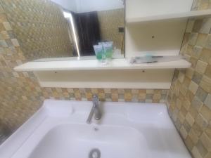 a bath tub with a sink and a mirror at Chalern Guesthouse in Luang Prabang +20 photos