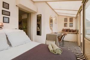 a bedroom with two beds and a table at Loft Duplex Terrasse View on Paris in Paris