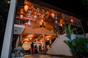 people standing outside of a building at night at French Villa in Dankotuwa