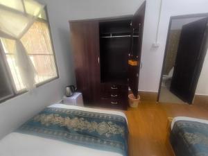 a room with a bed and a window and a window at Chalern Guesthouse in Luang Prabang