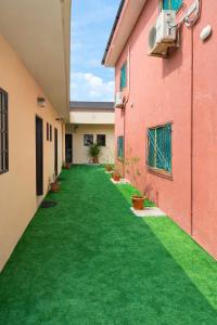 an empty corridor of a building with green grass at Résidence Gnimakel in Abidjan