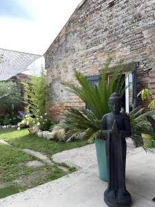 a statue of a person in front of a building at Chambre d'hôte Léontine in Lamagistère +9 photos