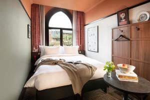 a bedroom with a bed and a table at Jan Luyken Amsterdam in Amsterdam