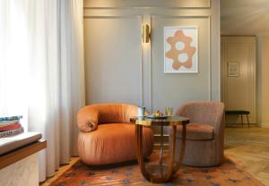 a living room with a chair and a table at Jan Luyken Amsterdam in Amsterdam +43 photos
