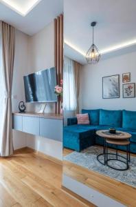 a living room with a blue couch and a table at Zlatibor 2 in Zlatibor