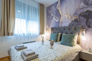 a bedroom with a bed with towels on it at Zlatibor 2 in Zlatibor +84 photos