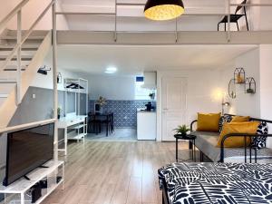 a loft apartment with a bed and a living room at Sint-Jans Appartments in Antwerp