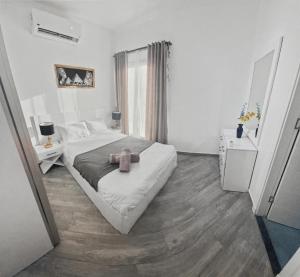 a bedroom with a bed with a teddy bear on it at 3BR 2BA Retreat with Four Pools Gym and Onsite Dining Close to El Gouna in Hurghada +39 photos