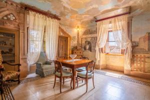 a dining room with a table and chairs at Palazzo Tombesi Trecci in Montepulciano