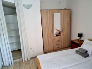 a bedroom with a bed and a door with a mirror at Lion Apartments in Vodice