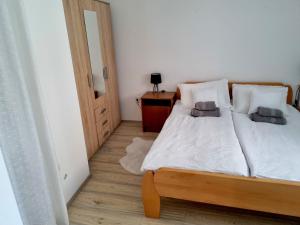 a bedroom with a bed with two pillows on it at Lion Apartments in Vodice +11 photos