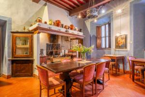 a dining room with a table and chairs and a fireplace at Palazzo Tombesi Trecci in Montepulciano +31 photos