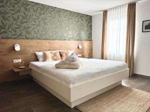 a bedroom with a large bed with a green wall at Adler Hotel und Restaurant Schiltach in Schiltach +11 photos