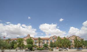 a large building with trees in front of it at GreenTree Inn and Suites Florence, AZ in Florence
