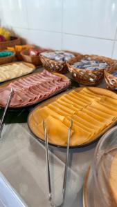 a table topped with plates of food and bowls at Pousada Mar da Vila in Cabo Frio