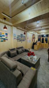 a living room with a couch and a table at Hotel Spiti House in Kaza
