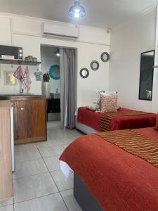 a hotel room with two beds and a bathroom at Magalies B&B LANGENHOVENPARK in Universitas