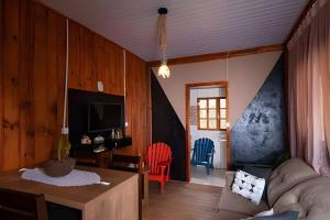 a living room with a couch and a table at Pousada Recanto da Paz in Urupema +51 photos