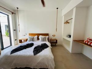 a bedroom with a bed with black bows on it at U PARADISU VILLAS - Private Pool in Jambiani