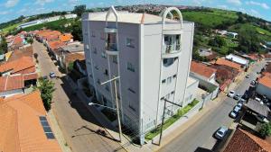 a tall white building with a cross on top of it at Matinada Palace Hotel in Paraguaçu