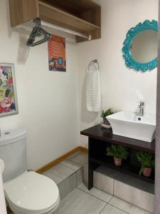 a bathroom with a white toilet and a sink at Magalies B&B LANGENHOVENPARK in Universitas