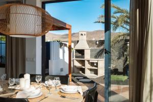 a dining room with a table and a view of the desert at Villa Zendaya in Yaiza