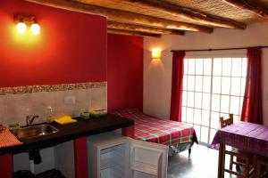a bathroom with a sink and a bed in a room at Cabañas Maimará in Maimará