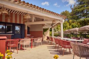 a row of tables and chairs on a patio at La Bastide de Mougins, a Tribute Portfolio Hotel in Mougins