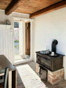 an outdoor kitchen with a stove in a room at Rural Guest House Between Simrishamn And Skillinge in Simrishamn +31 photos