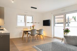a kitchen and dining room with a table and chairs at Chiemsee Apartment 17 in Übersee