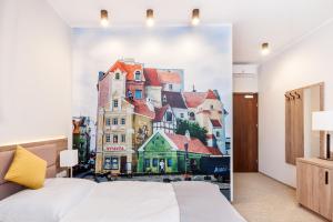 a bedroom with a wall mural of a building at Meet Poznań Hotel in Poznań