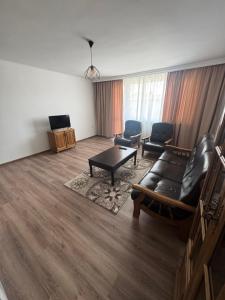 a living room with a couch and chairs and a table at Luxury House LUXIMMO in Lyetnitsa +6 photos