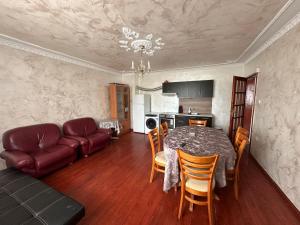 a living room with a table and a couch at Luxury House LUXIMMO in Lyetnitsa