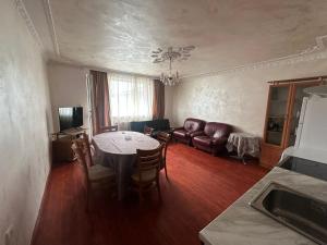 a living room with a table and a couch at Luxury House LUXIMMO in Lyetnitsa