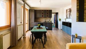 a living room with a table and a kitchen at Moderno Attico a due passi dal Mare in Senigallia