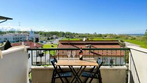 a table on a balcony with a view of a city at Moderno Attico a due passi dal Mare in Senigallia